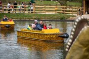 Family in leopard themed electric boat