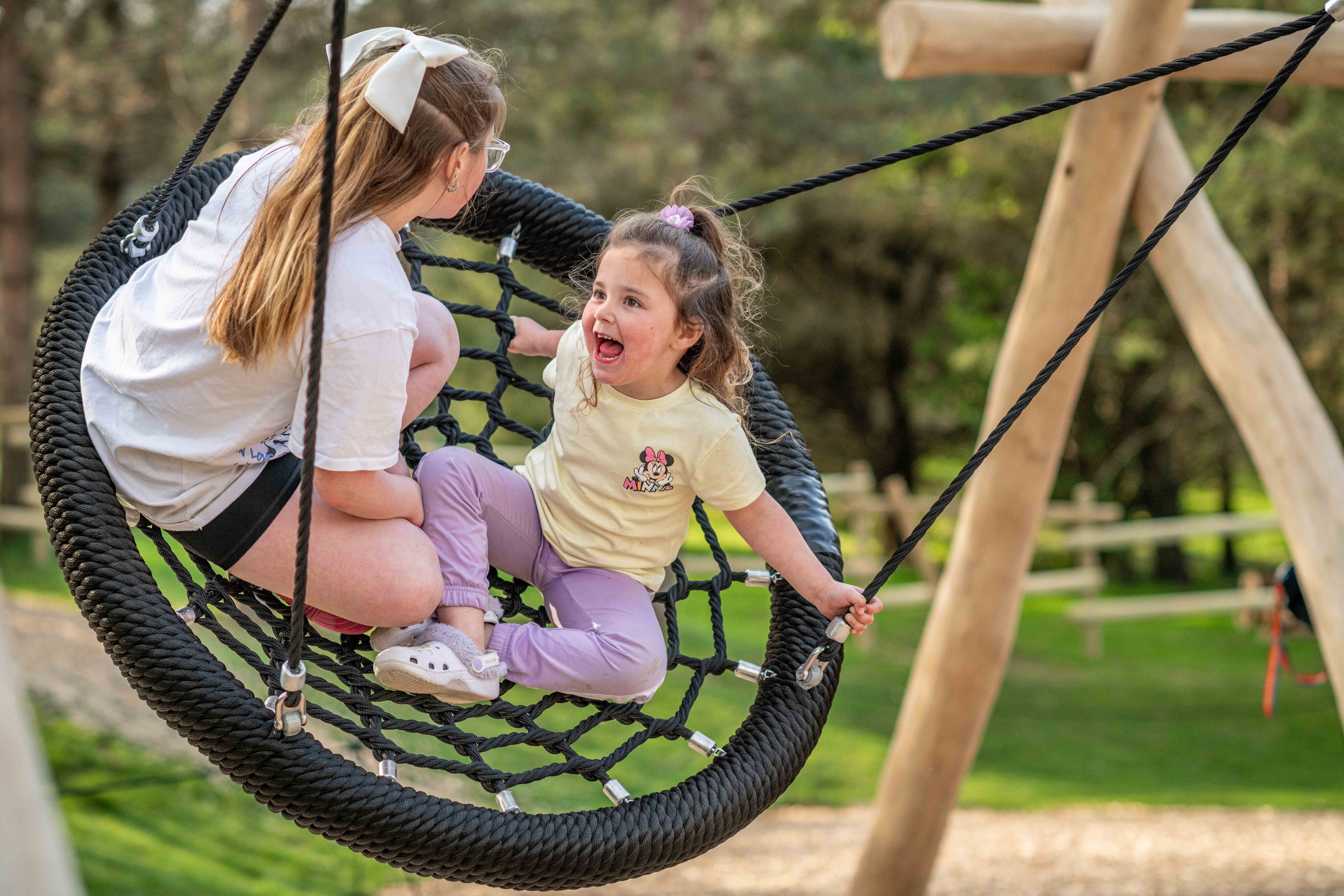 young girl on round swing