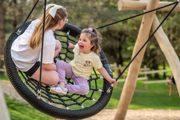 young girl on round swing