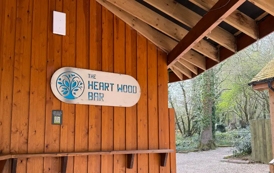 Wooden Bar in the woods with a silver metal sign