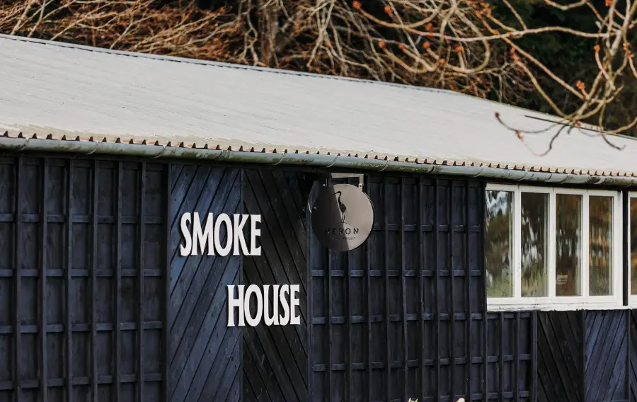 Black barn restaurant with a sign saying 'Smoke House'