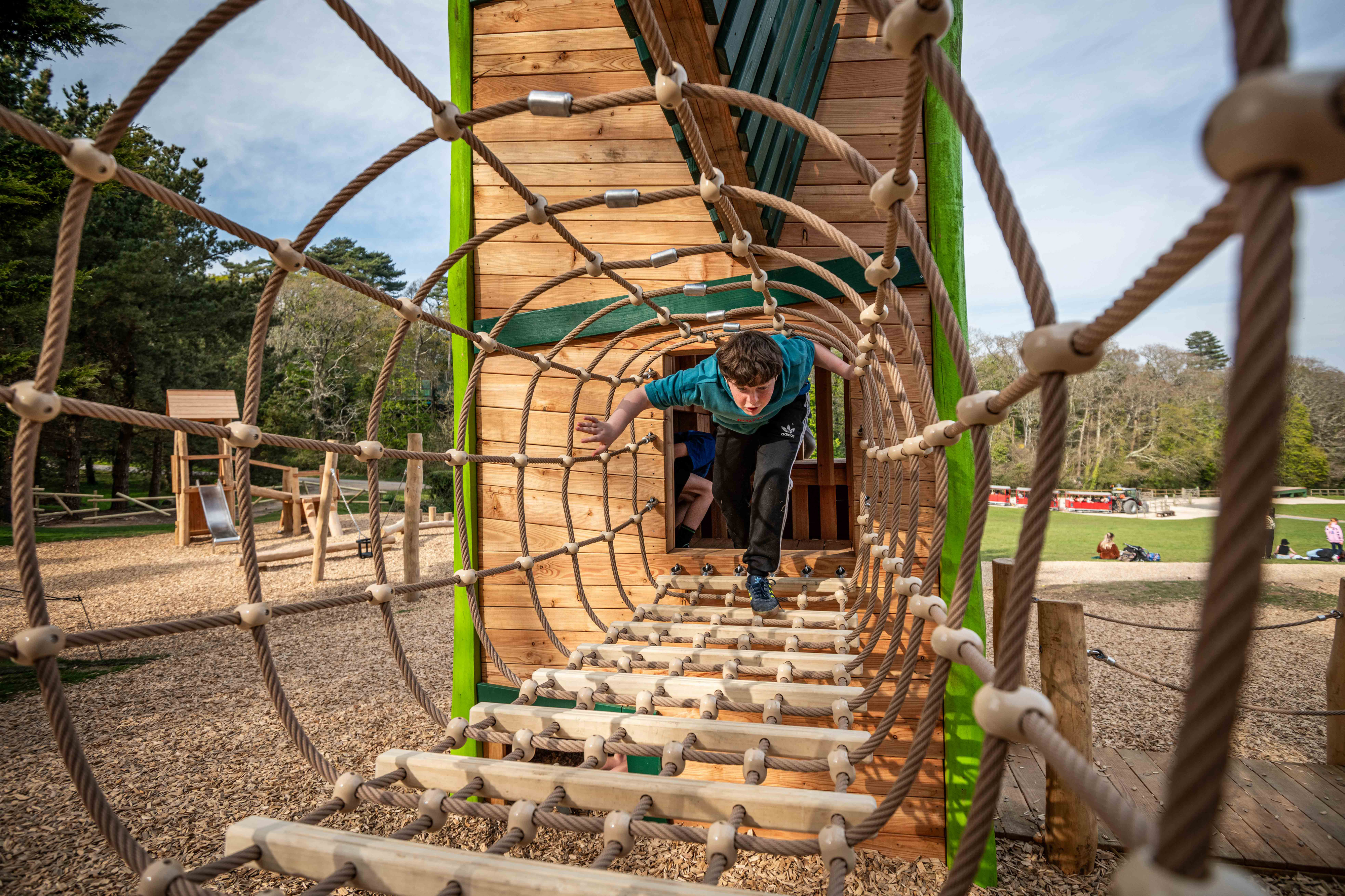 teen boy playing on wooden play area