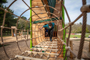 teen boy playing on wooden play area