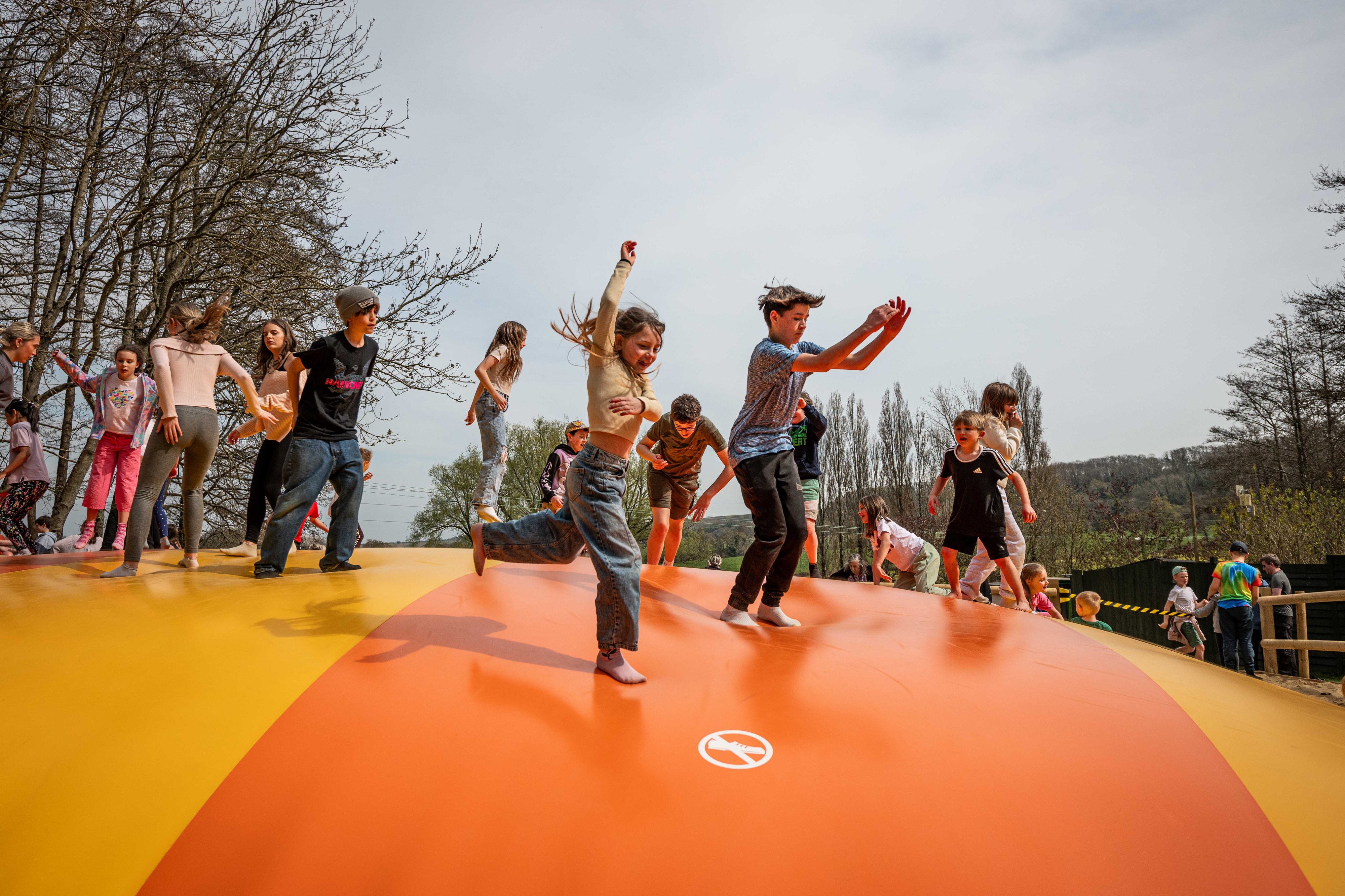 Children jumping on large bouncy pillow at Robin Hill Adventure Park