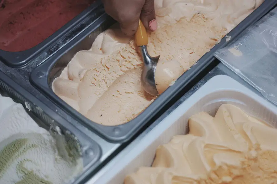 Vanilla ice cream being scooped 