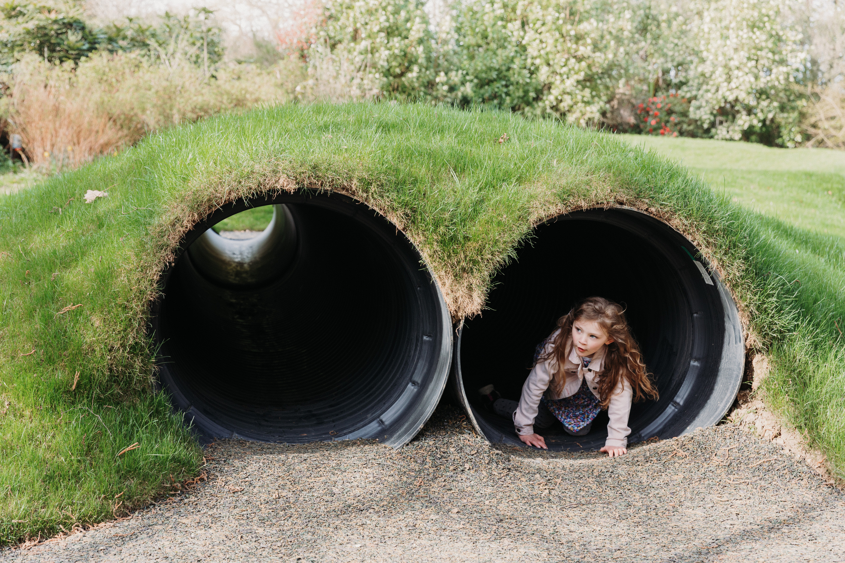 Young girl playing in tunnel 