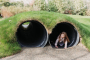 Young girl playing in tunnel 
