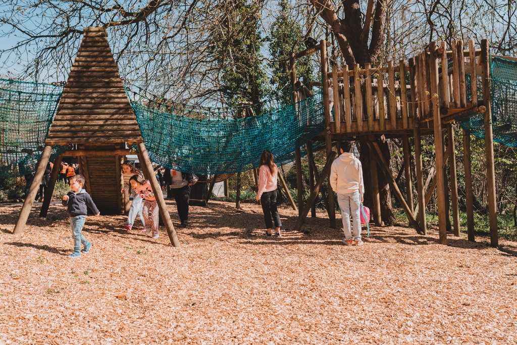 Children playing on a wooden play area