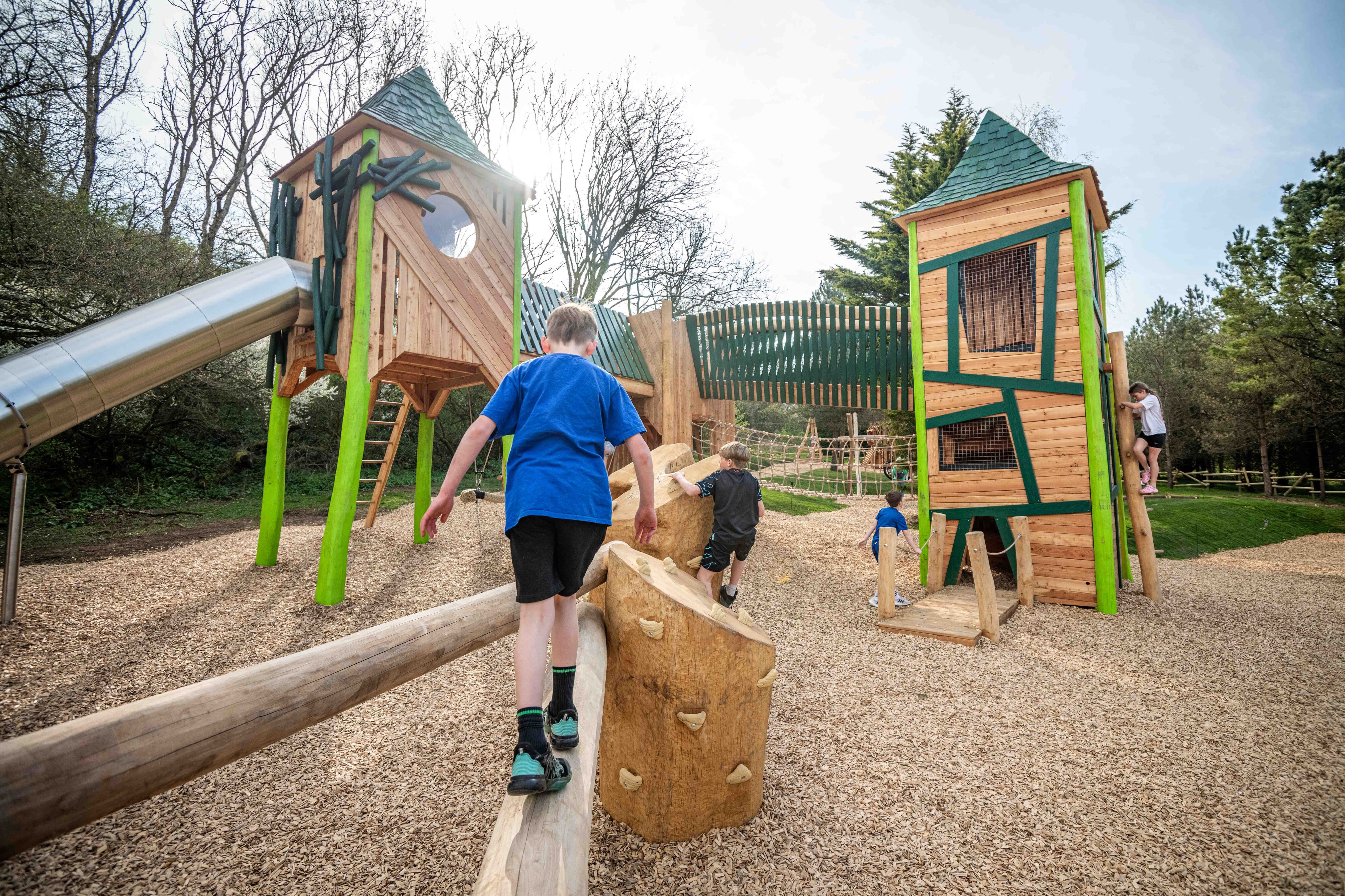 Boy pictured playing on a large wooden play area