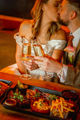 Couple with champagne on their wedding day with delicious food infront
