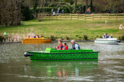 Families on safari animals themed electric boats