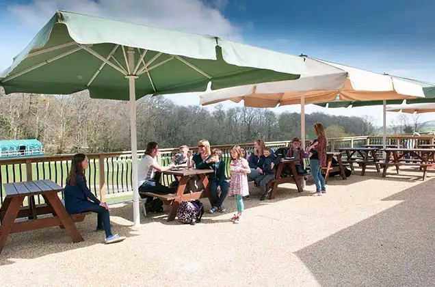 Picnic benches and parasols outside of Oasis cafe