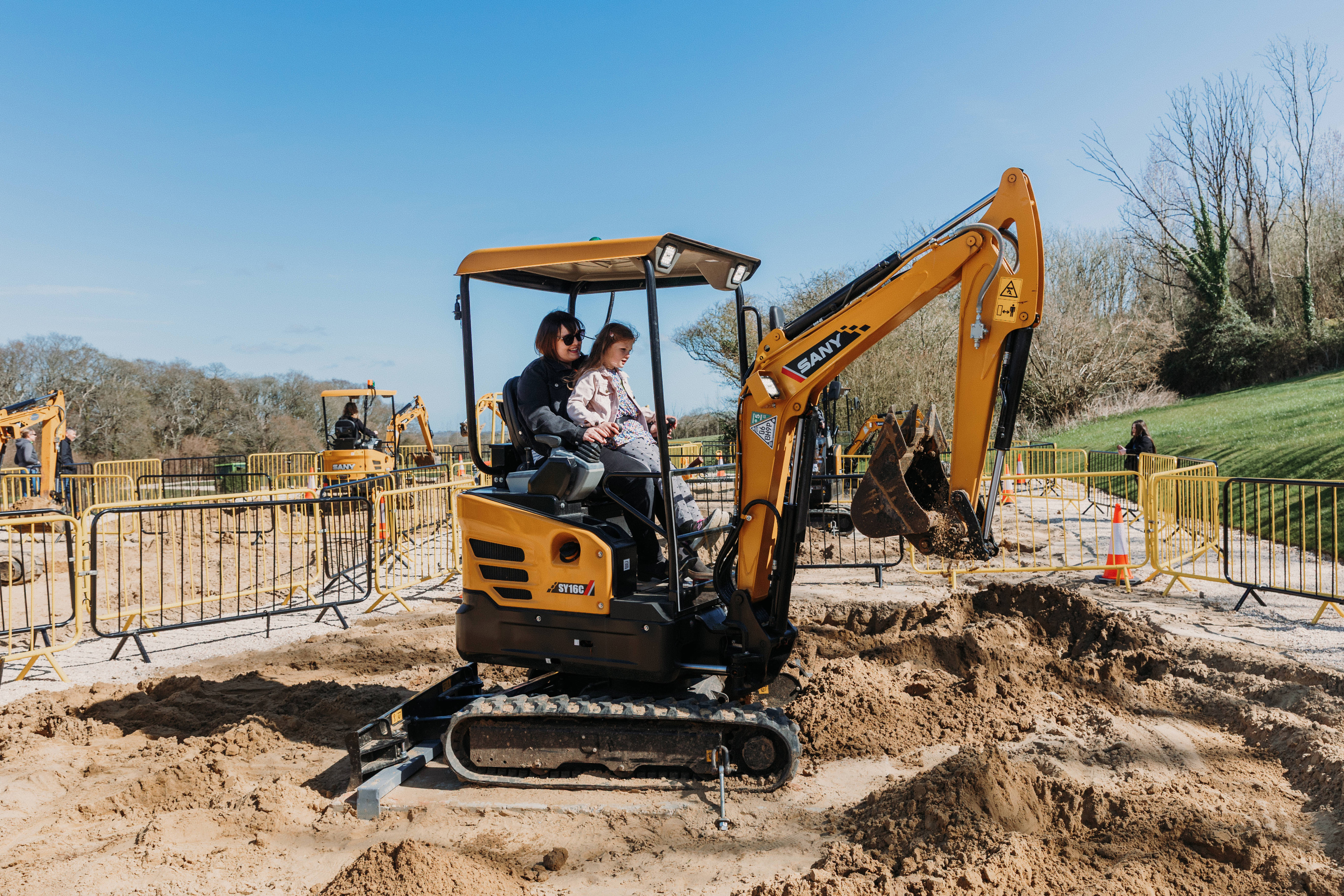 Mother and Daughter playing on toy digger