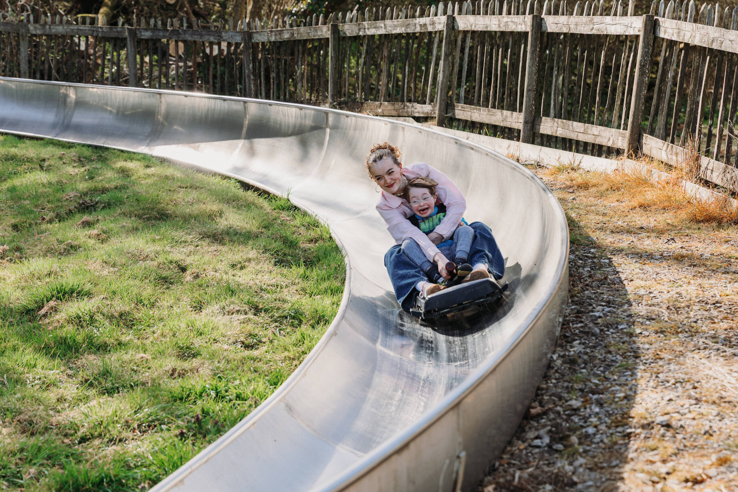 teen girl and young boy on toboggan at Robin Hill Adventure Park